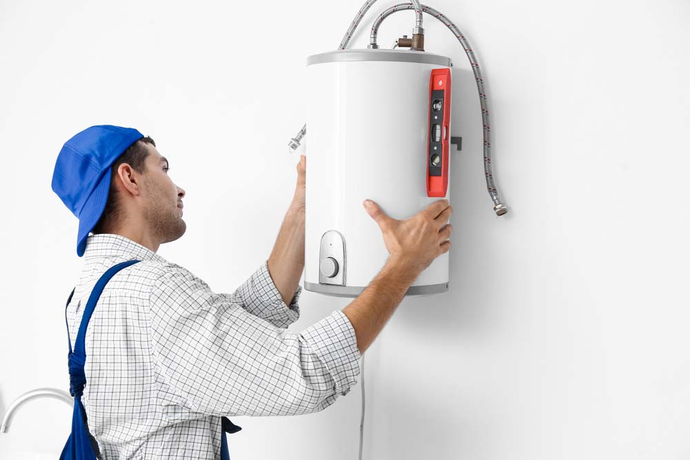 person holding water heater unit